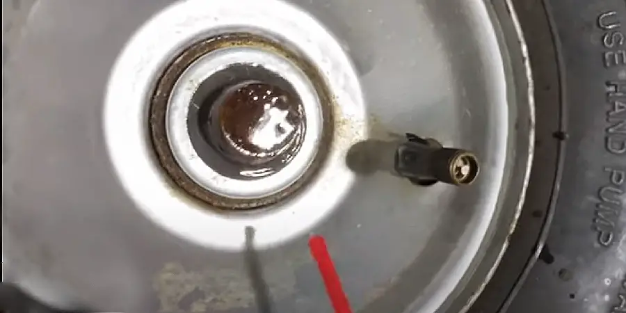 Apply a penetrating oil to the lock washer area on the dolly wheel